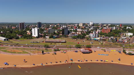 a captivating aerial view of encarnación city in paraguay with a stunning coastline along san josé beach.