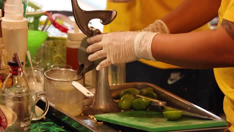 person making lime juice at a street stall