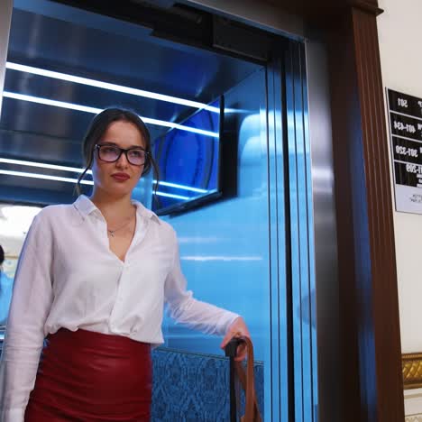 young woman exits the elevator
