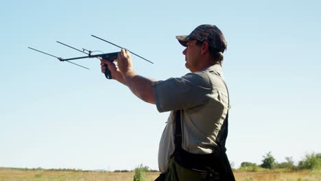 man aiming with crossbow