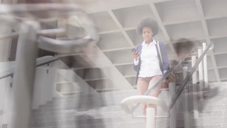 animation of african american businesswoman using smartphone over people walking