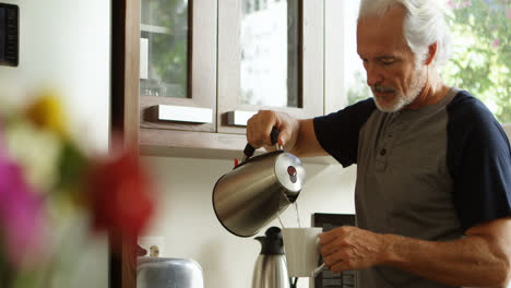 hombre mayor preparando café en la cocina 4k