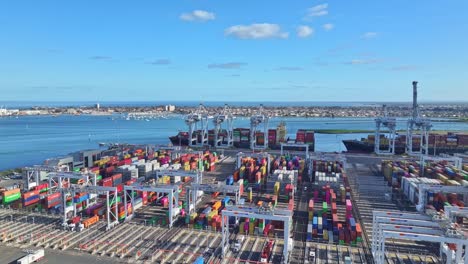 aerial view of cranes ships and stacked containers at victoria international container terminal