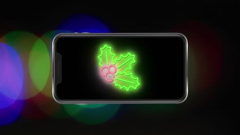 Animation-of-leaves-on-smartphone-at-christmas-over-light-spots