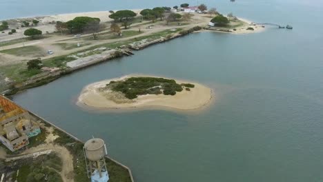 drone shot fly towards the island abandoned old bay, seixal