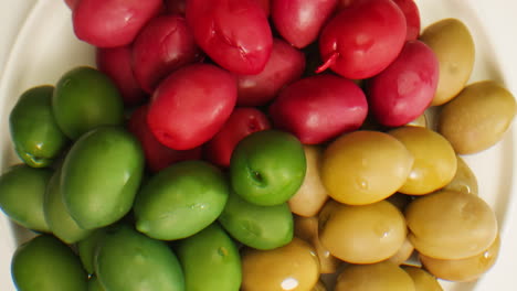 pickled round green olives from greece as background, top view. high quality 4k footage