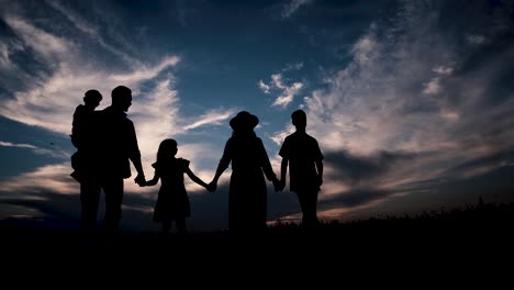 a Family on the Background of the Sunset Walks Holding Hands a Family on the Background of the Sunset Walks Holding Hands Silhouettes on the Background of the Sunset a Happy and Strong Family