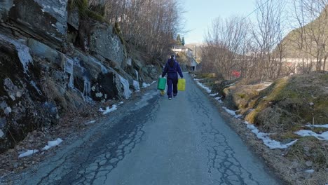 woman carries plastic waste removed from norway coastline
