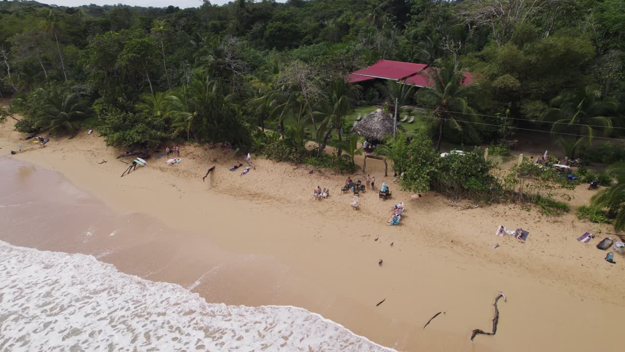 Aerial View of Tropical Beach with Resort and People