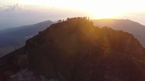 people on the top of mt rinjani during sunrise, aerial shot