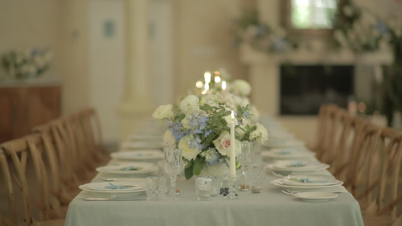 White table setting with white rose centrepiece, panning