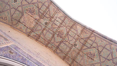 looking-up-at-the-tiling-on-the-ceiling-of-an-islamic-archway-in-Samarkand,-Uzbekistan-along-the-historic-Silk-Road