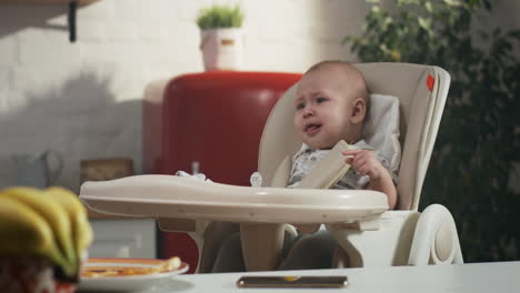 baby crying in highchair