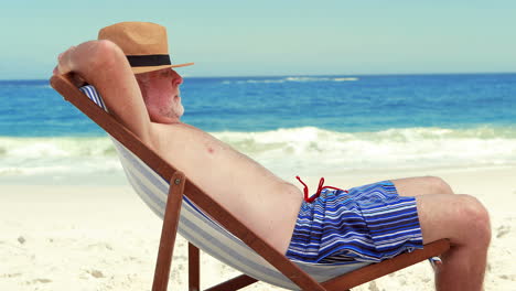 Senior-man-sleeping-on-deck-chair