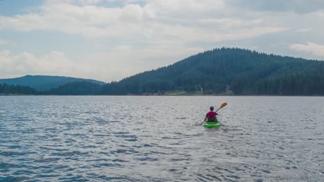 kayaking solo across a serene mountain