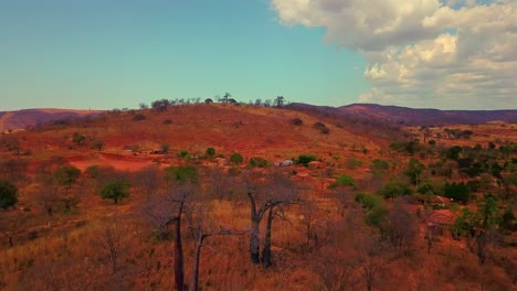 disparo aéreo de un dron volando hacia atrás sobre árboles muertos secos cerca de un pequeño pueblo en la zona rural de bahía, brasil