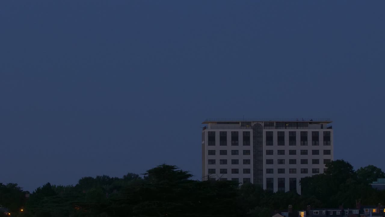 Building Silhouetted Against Colorful Sunset Skies