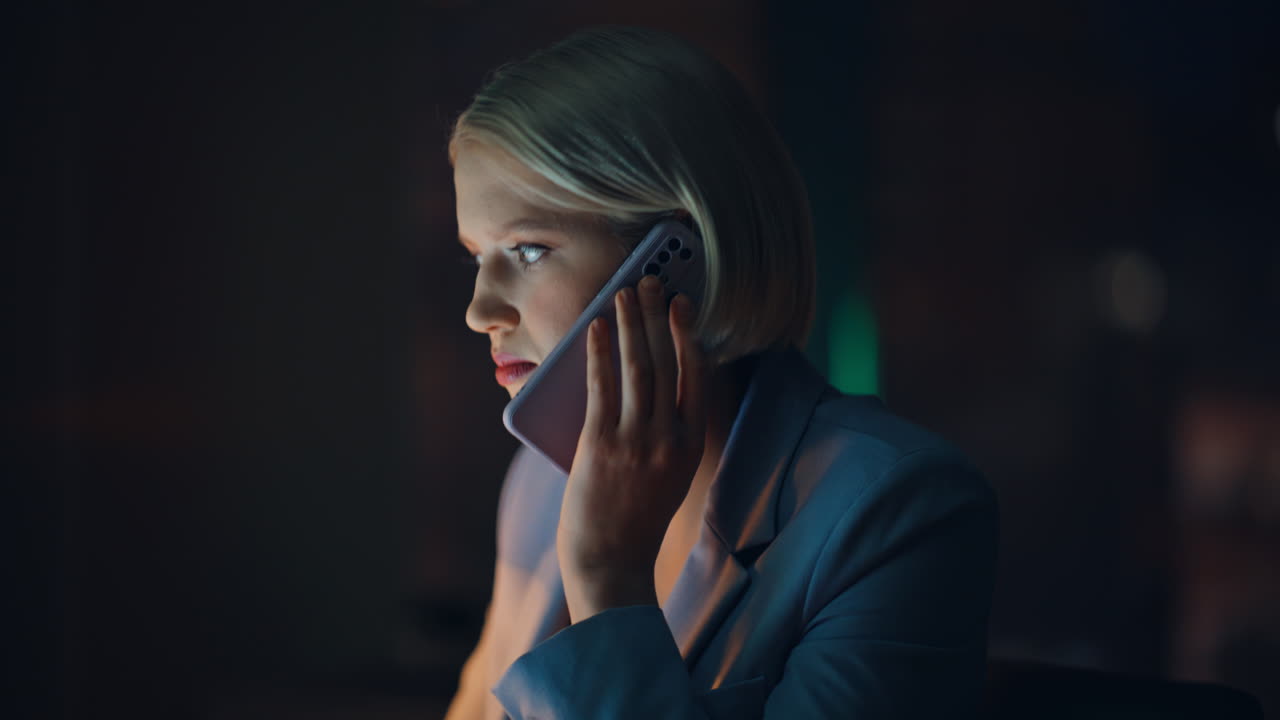 Night manager talking mobile phone at workspace closeup. Businesswoman calling