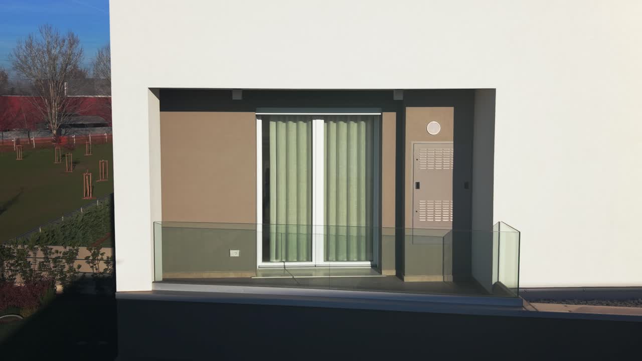 Close-up view of a modern window and balcony facade in a contemporary residential building. Clean architectural lines, minimal design and sustainable housing concept under daylight