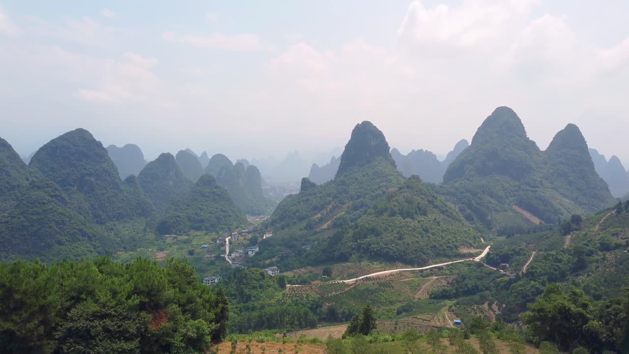 Clip of a karst mountain landscape and terraced tea plantation landscape on a sunny day, China