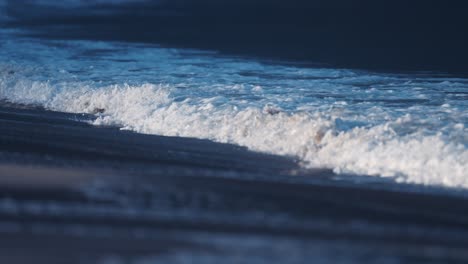 the powerful waves break around the sandy shallows on the ersfjord beach