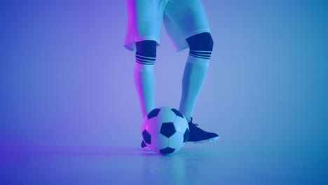 football dribbling ball in studio player is showing professional skills closeup of feet of player