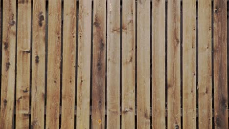 snow falling in slow motion against a background of wooden fence