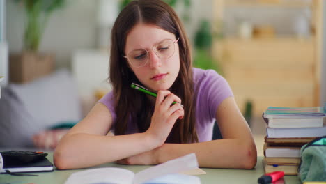 Young Student Reflects While Studying and Is Thoughtful