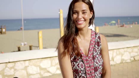 Smiling-friendly-woman-on-a-seafront-promenade