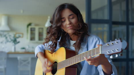 happy musician playing chords on guitar