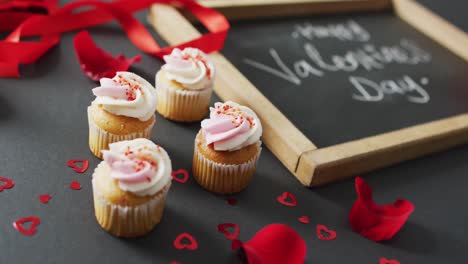 happy valentine's day text and cupcakes on gray background