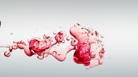 transparent red oil bubbles and fluid shapes in purified water on a white gradient background