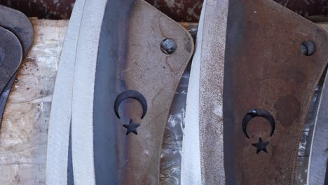 closeup of metal blades with crescent moon and star designs