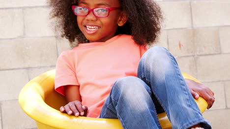 young black girl spinning in school playground, close up