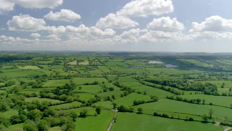 picturesque aerial of glorious green english fields against a blue sky and perfect clouds