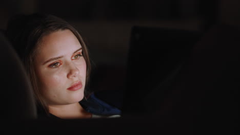 beautiful teenage girl using tablet computer watching entertainment at night browsing online enjoying relaxing evening