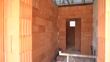 interior view of brick partition walls inside unfinished house under construction