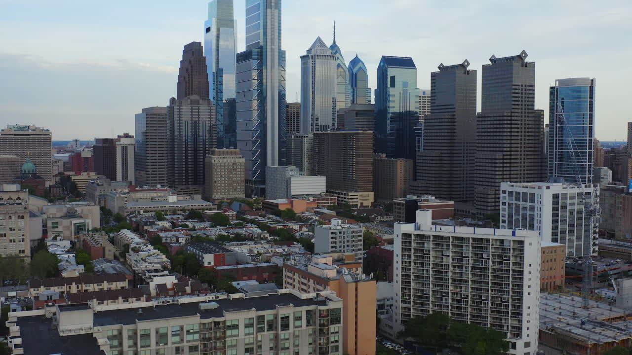 Aerial drone revealing the Philadelphia city skyline showcasing Comcast Technology Center and tall east coast skyscrapers and buildings from Schuylkill River Trail