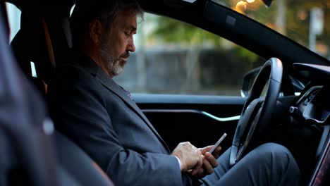 businessman using mobile phone in a car 4k