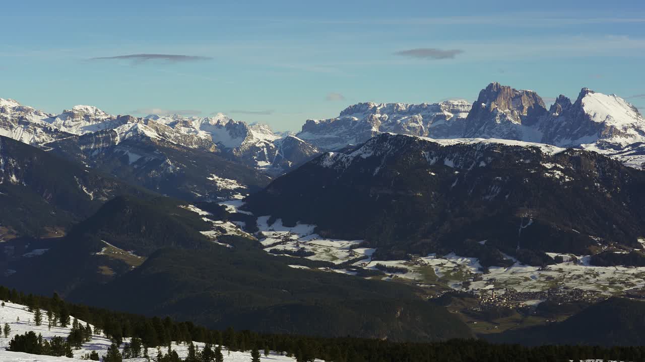 slow panning view in the alps of the epic peaks of the snow capped mountains of the Dolomites in winter