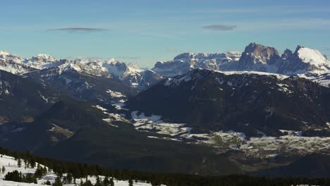 slow panning view in the alps of the epic peaks of the snow capped mountains of the dolomites in winter