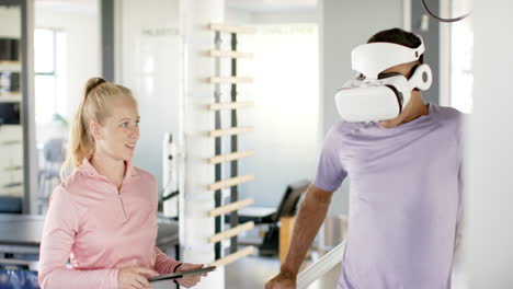 using vr headset, man in disability rehab with therapist holding tablet