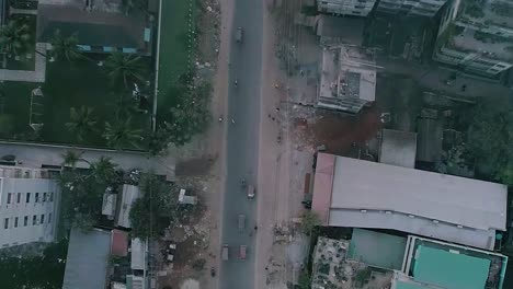 areal shot of a road from a rural area where vehicle's are passing