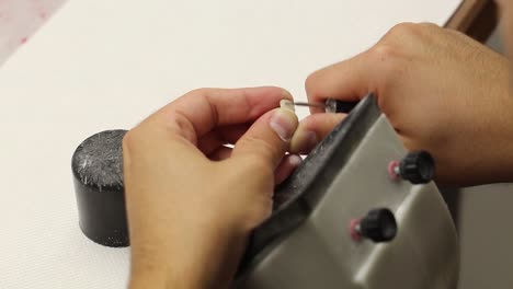 male doctor working on tooth crown at stomatology clinic