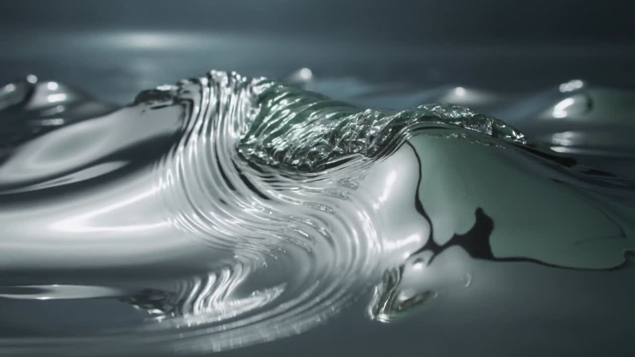 Metallic surface forming crest from impact, sending ripples, showing specular highlight for VFX