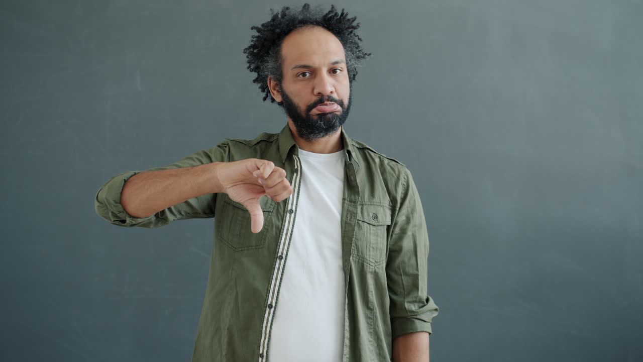 Man Showing Thumbs Up and Thumbs Down