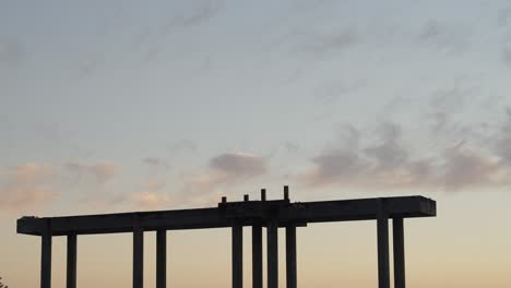 Structure-silhouette-with-orange-sunset-and-pink-clouds