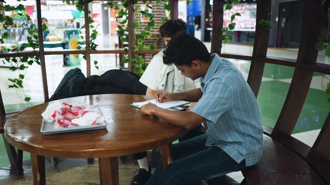 Side view camera capturing warm light beams radiating along polished floor while neat bags sit atop desk and nearby table under soft beam adding modern ambiance to work setting with smooth motion