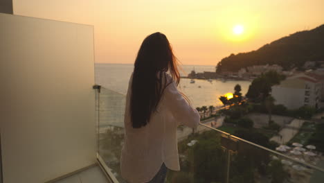 woman on balcony at sunset