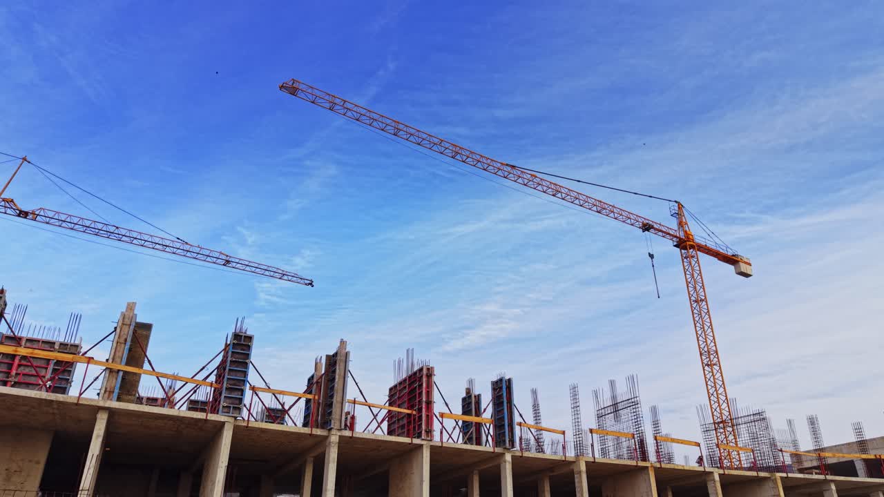 Construction site aerial view showcasing cranes and building framework
